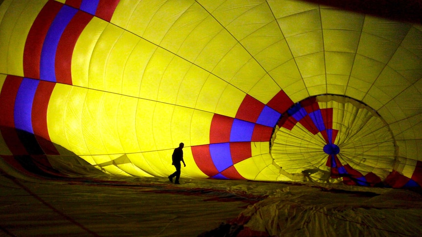 A hot air balloon pilot prepares a balloon for take off.