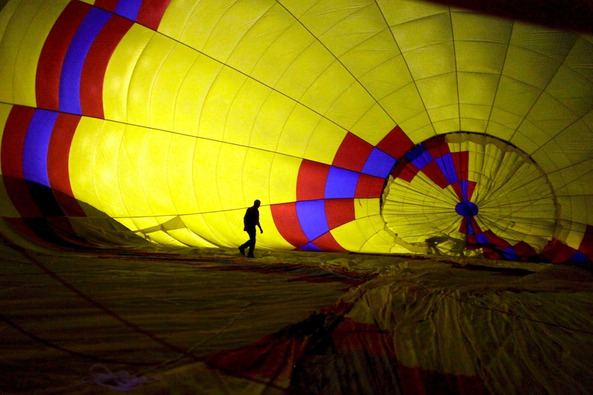A hot air balloon pilot prepares a balloon for take off.