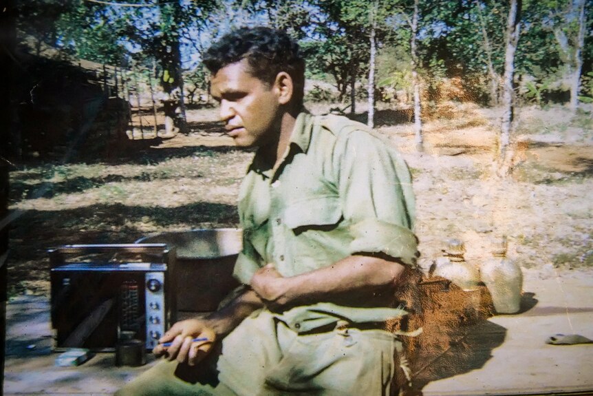 A man in army fatigues in a bush setting