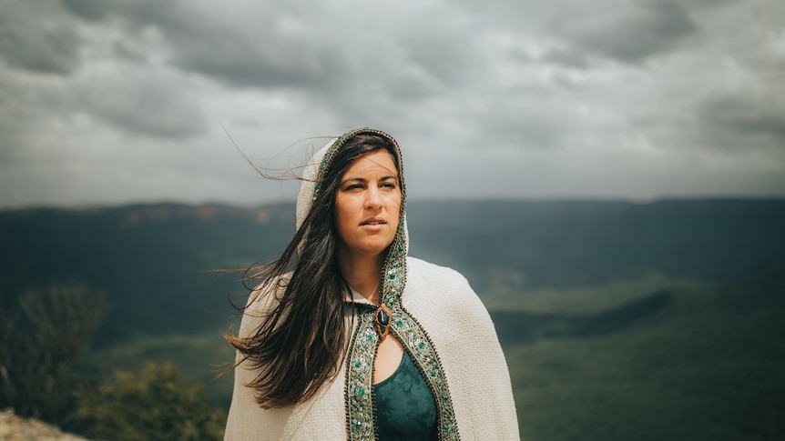 Julie Brett stands on a cliff in the Blue Mountains.