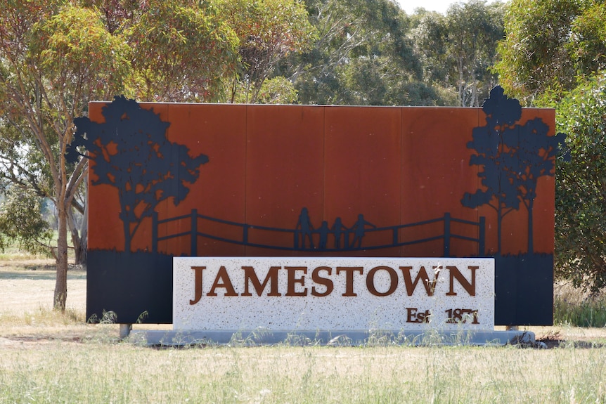 A metal town entrance sign reads "JAMESTOWN Est 1871" with gum trees in the background. 