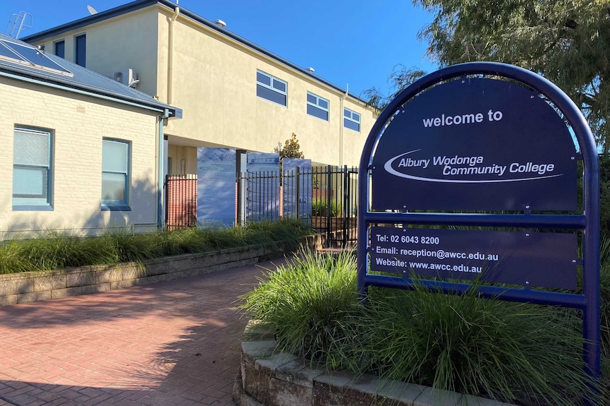 large white building with blue sign at front saying welcome to albury wodonga community college