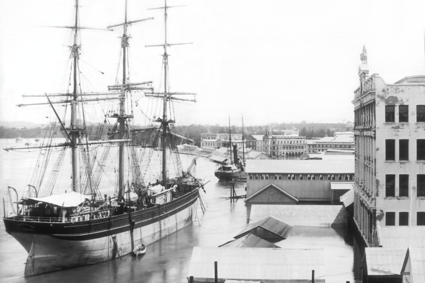 A ship docked at a wharf in Brisbane in the 1800s.