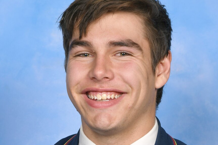 School photo of Nick Boffa smiling in his school blazar. 