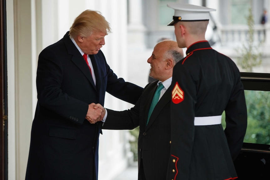 Donald Trump greets Iraqi Prime Minister Haider al-Abadi at the White House in Washington.