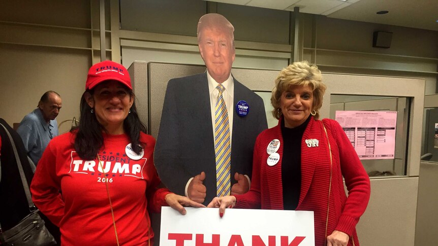 Trump campaign supporters hold a sign saying 'Thank you'.
