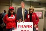 Trump campaign supporters hold a sign saying 'Thank you'.