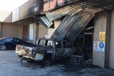 Burnt-out ute and shop on Gladstone Street in Fyshwick.