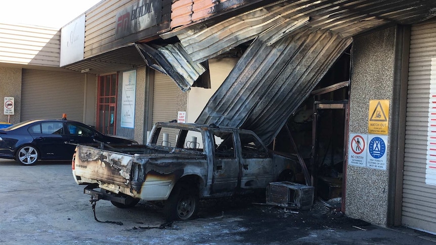 Burnt-out ute and shop on Gladstone Street in Fyshwick.