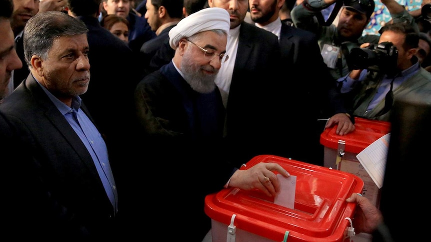 Iranian President Hassan Rouhani casts his vote during the presidential election in Tehran, Iran.