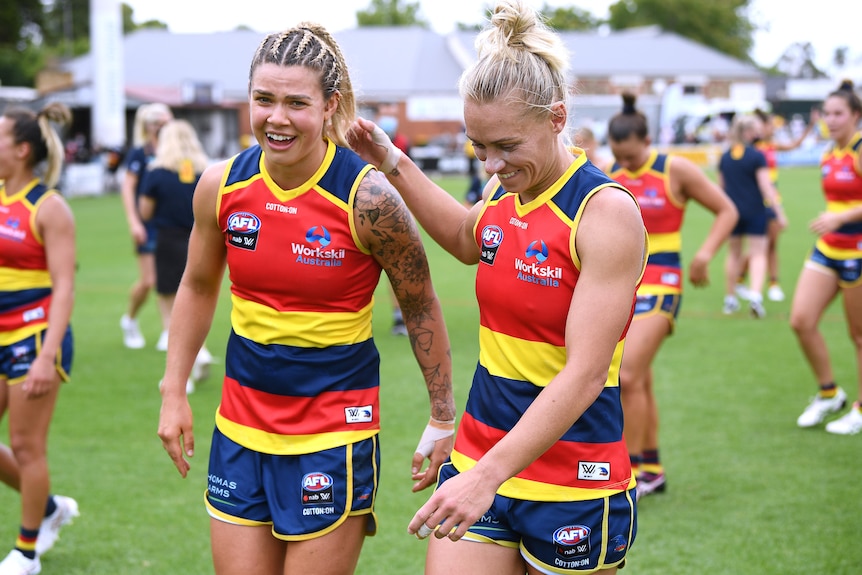 Erin Phillips puts her hand on Anne Hatchard's shoulder as the two leave Norwood Oval