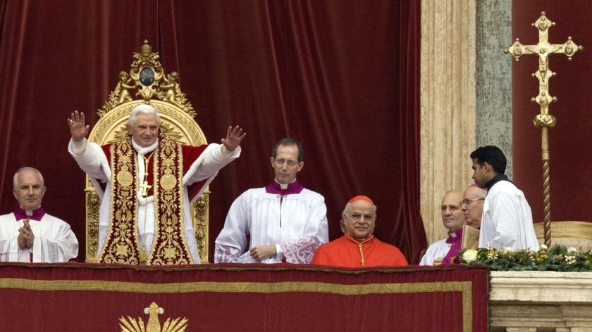 Pope Benedict XVI waves his faithful as he leads his Urbi et Orbi Christmas message