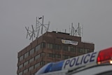 Broken wind turbines atop Hobart Marine board building.