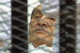 Hosni Mubarak lies on a stretcher at the opening of his trial