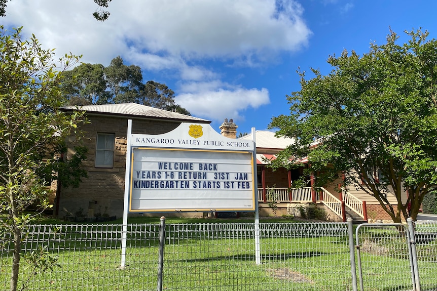 A school sign in front of a public school