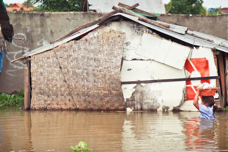 Girl wades through Cambodian floods