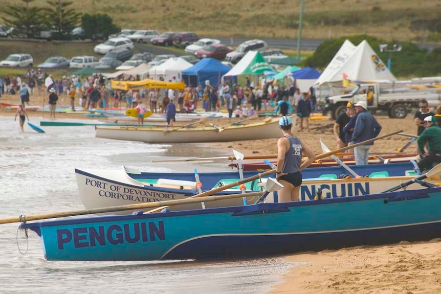 surf boats lined along the beach and lifesavers milling about