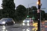 Cars drive through floodwaters in Elwood, Melbourne, around 8:00pm (AEDT) on February 5, 2011, after