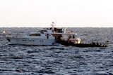 Israeli soldiers board one of the two Gaza-bound boats carrying pro-Palestinian activists