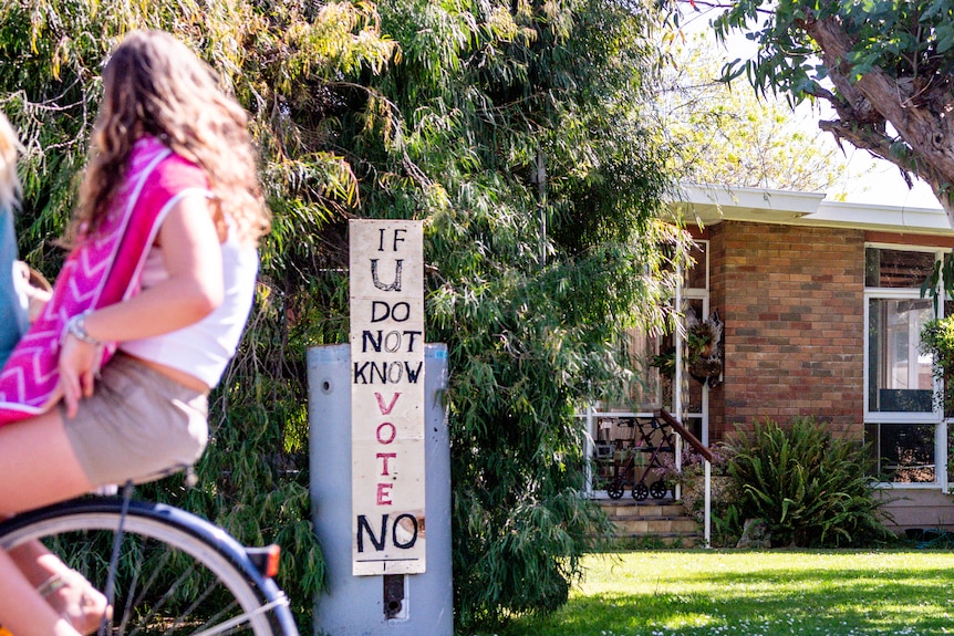 A home with sign out front reading, if you don't know, vote no