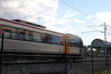 A train speeding past a station.