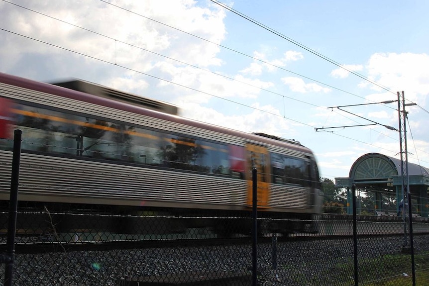 A train speeding past a station.