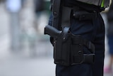 A Police officer is seen carrying a gun holster