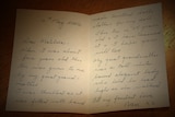 Close-up of hand-written letter on table