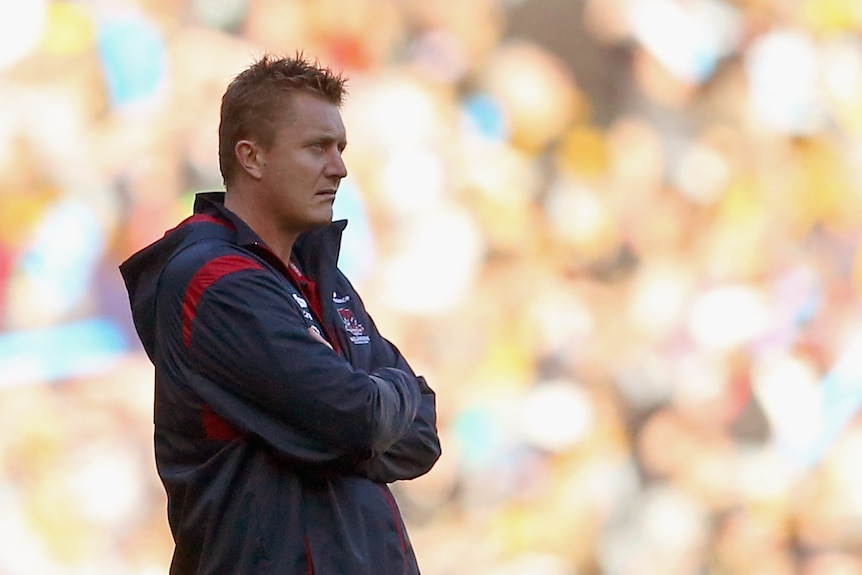 Mark Neeld the coach of the Demons looks on from the sidelines during an AFL match.