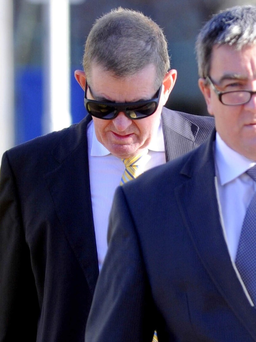 Peter Slipper keeps his head down as he arrives at the ACT Magistrate Court.