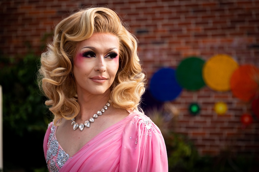 A head and shoulder shot of Cougar Morrison in a pink dress and glittery jewellery.