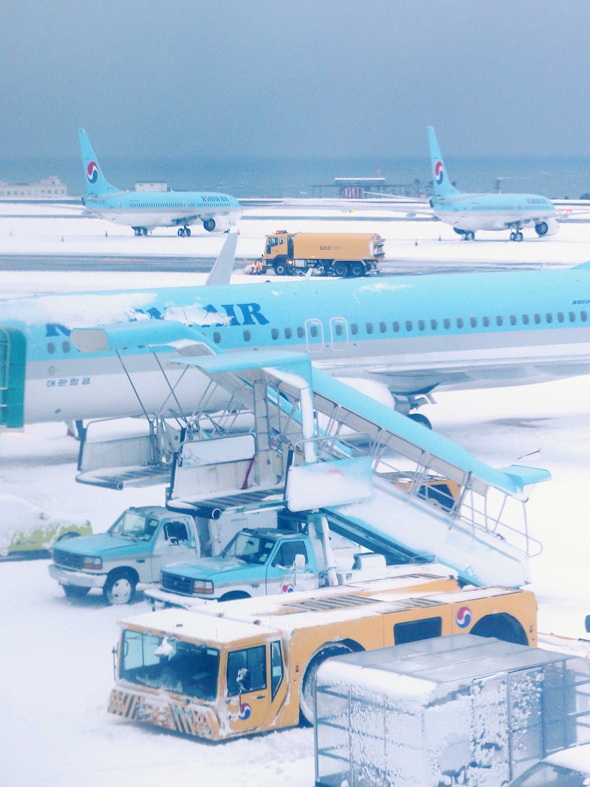 A general view shows planes snow coverage at Jeju airport.