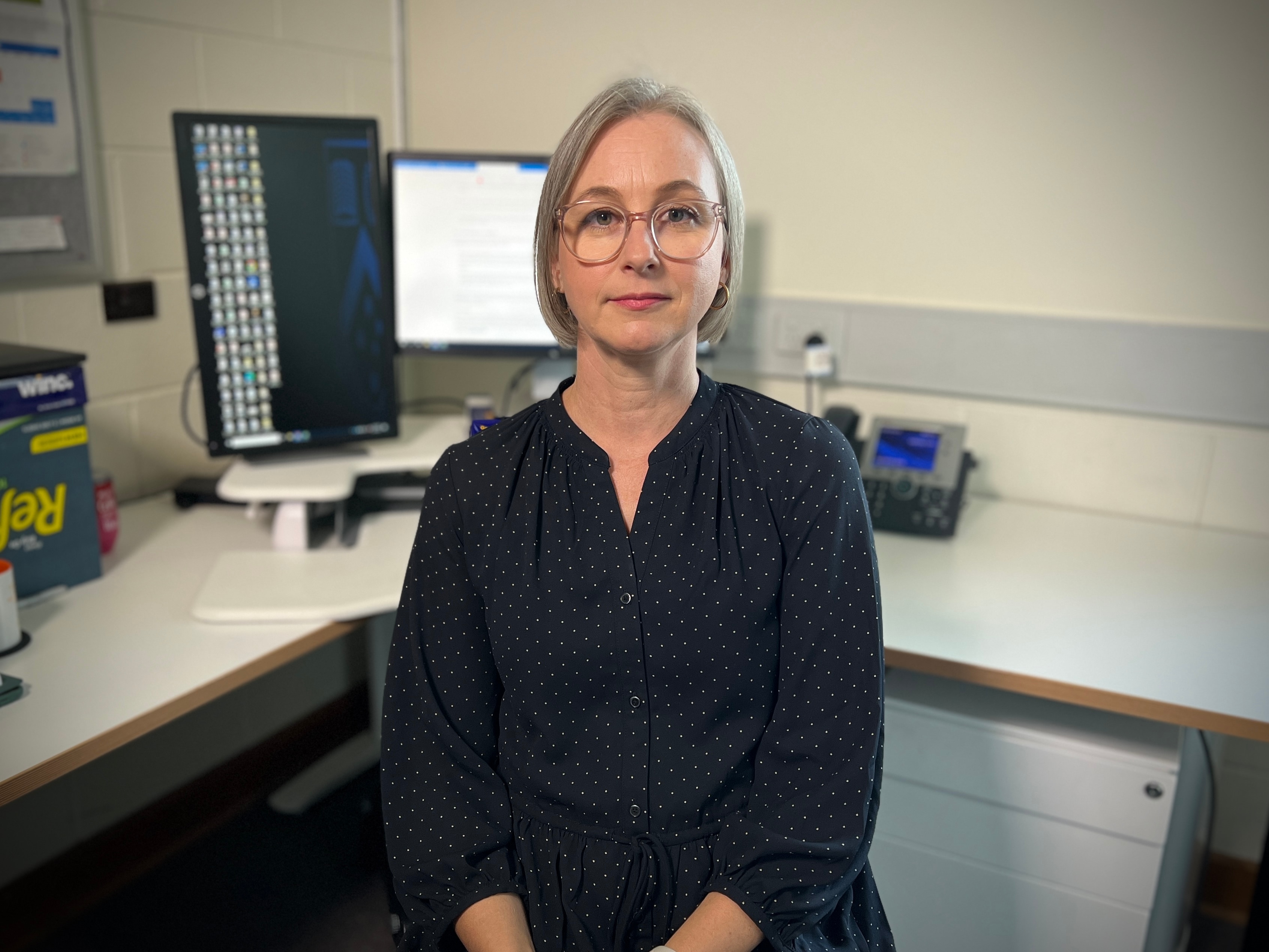 A woman sitting in front of an office desk