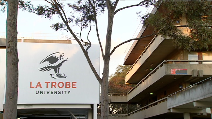 La Trobe University sign in front of dull brown brick building.