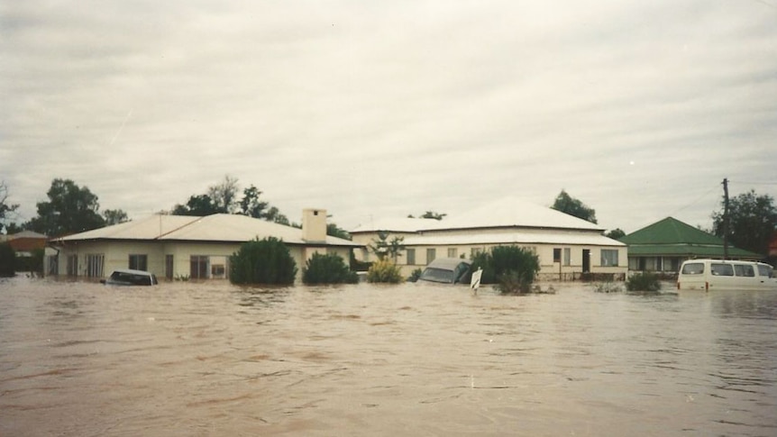 Flooded houses and cars on corner of Sturt and Edward streets in Charleville in 1990 flood