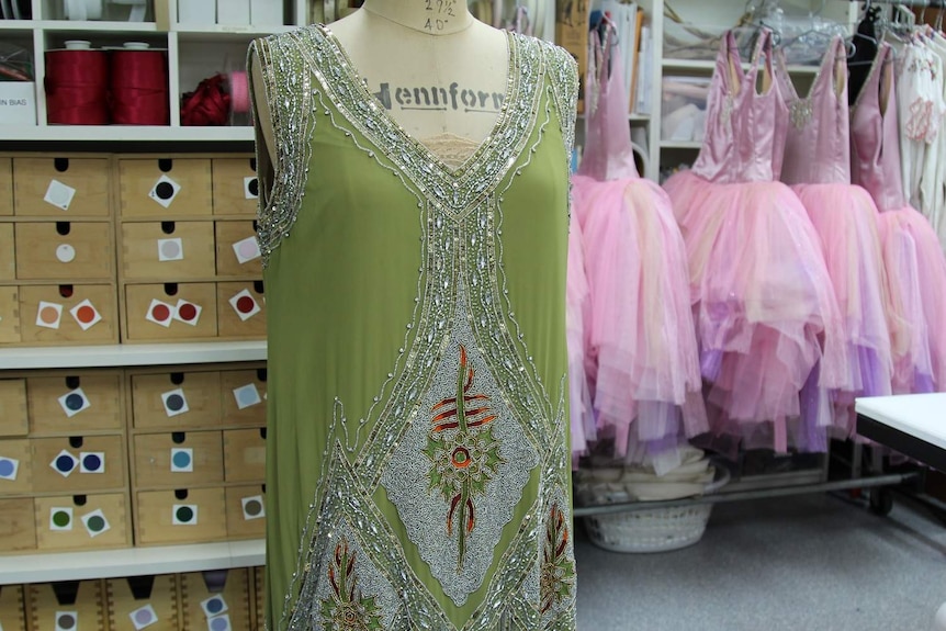Flapper-style beaded dress with pink tutus in background