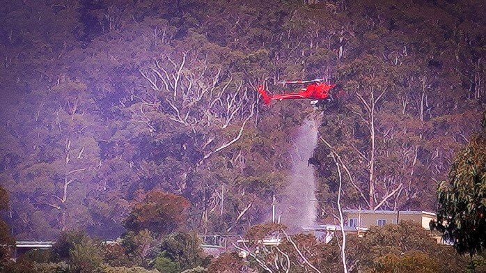 Helicopter drops water on homes.