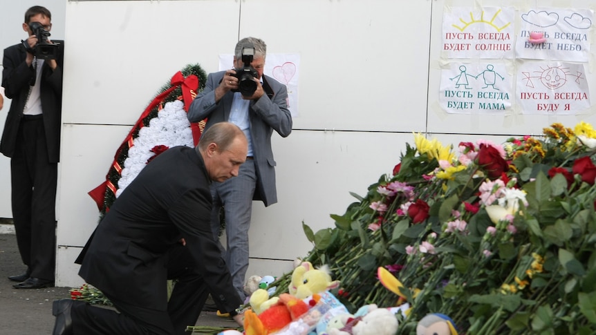 Russian prime minister Vladimir Putin pays tribute to boat victims