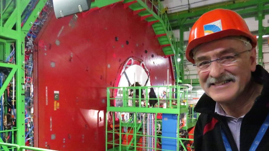 Astronomer Fred Watson underground at the Large Hadron Collider with lots of machinery in the background