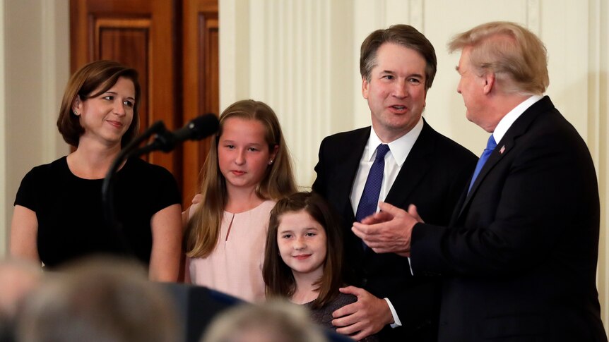 Brett Kavanaugh with his family and Donald Trump