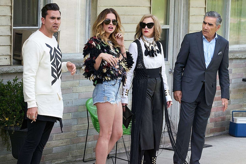David, Alexis, Moira and Johnny Rose stand outside the hotel at Schitt's Creek.