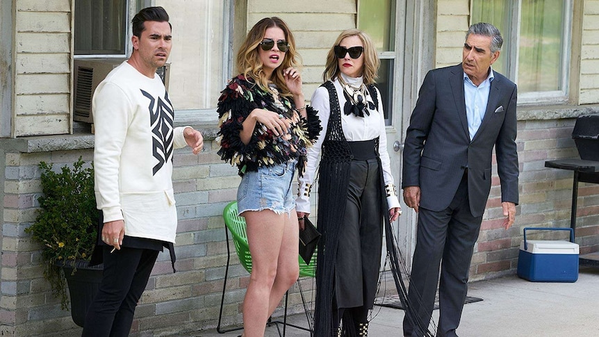 David, Alexis, Moira and Johnny Rose stand outside the hotel at Schitt's Creek.