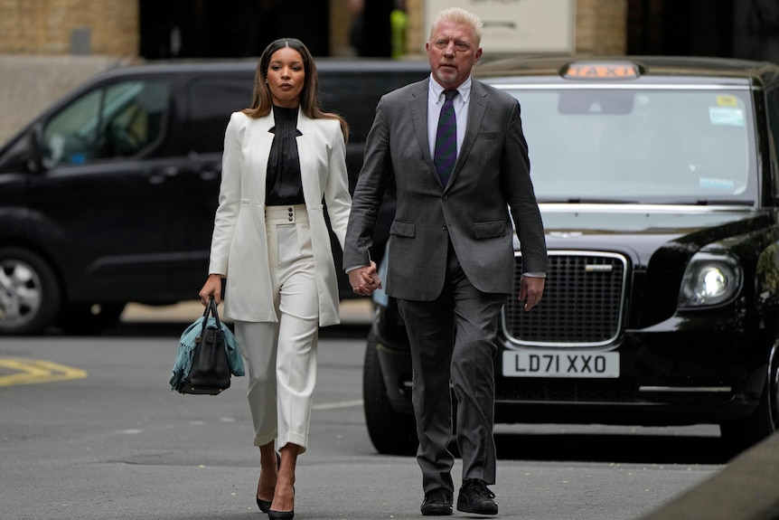 Former Tennis player Boris Becker holds hands with Lilian de Carvalho Monteiro as they walk in the street.