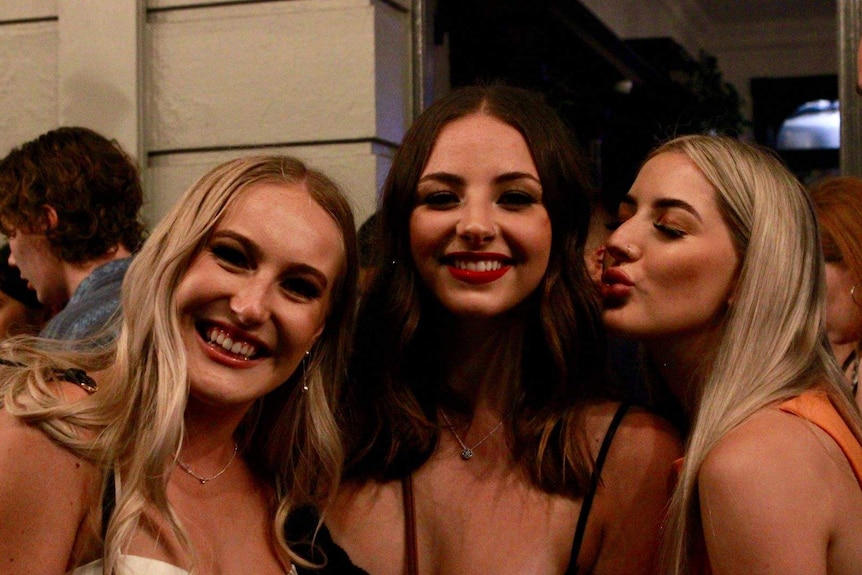 Three young women enjoying a night out in Fremantle.
