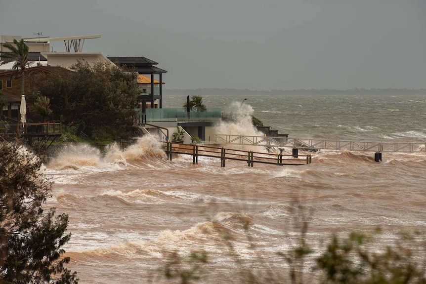Waterfront homes being hit by large waves and rough surf