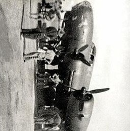 A black and white photo of an air forces bomber with people standing below it