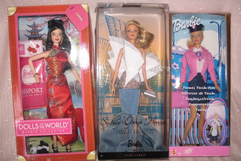 Three Barbie dolls still in their boxes. 