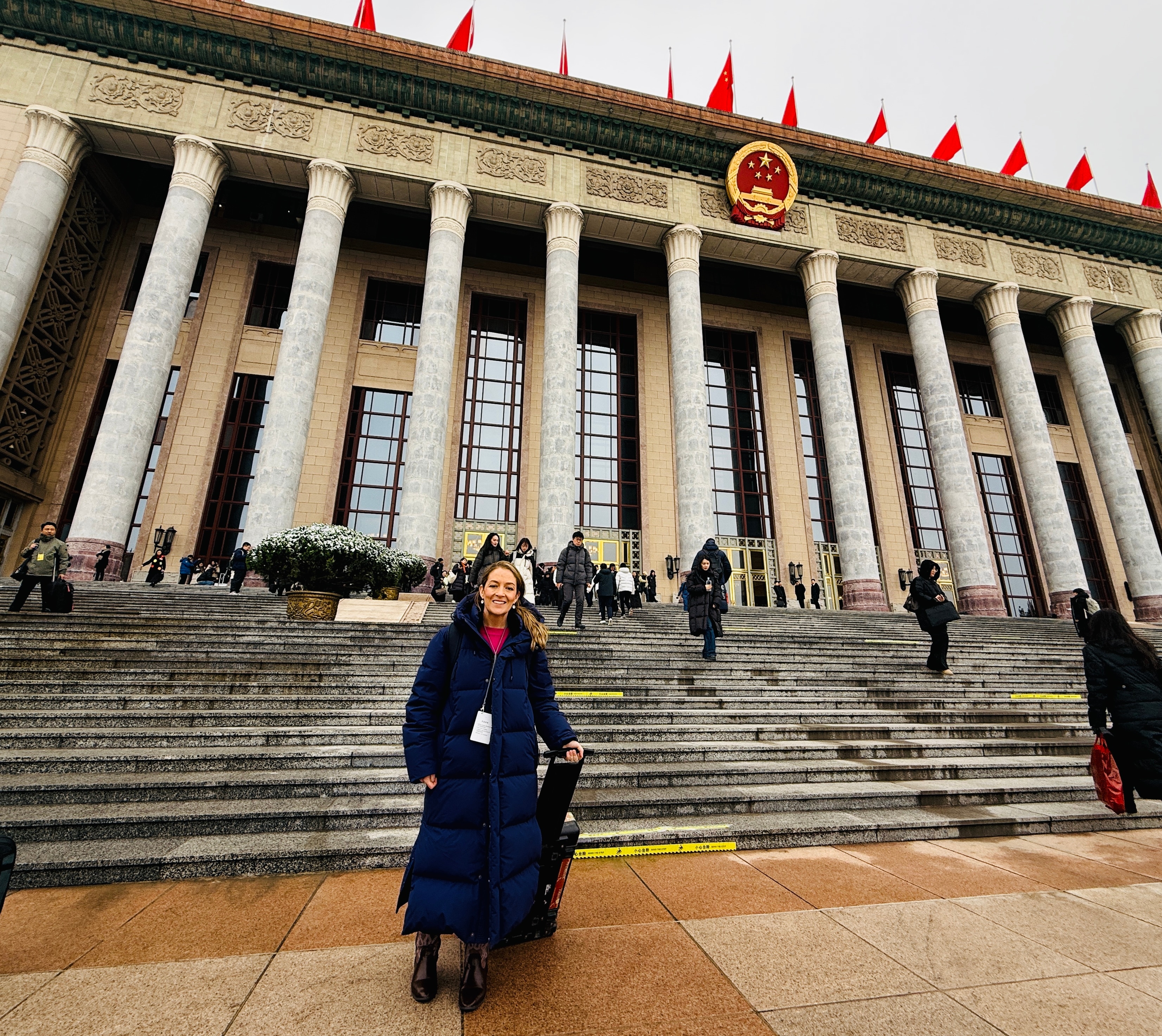 woman in front of pillared building.