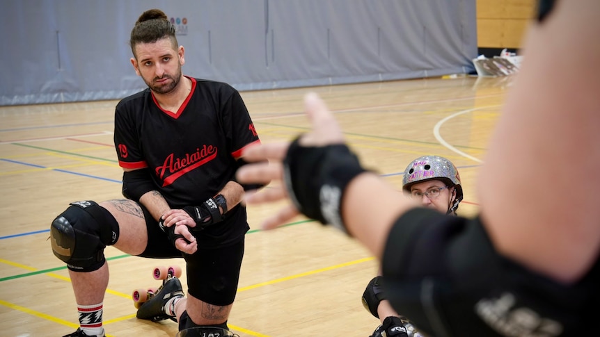Ashley Wilkinson rests on a knee during a break in training for the national roller derby titles
