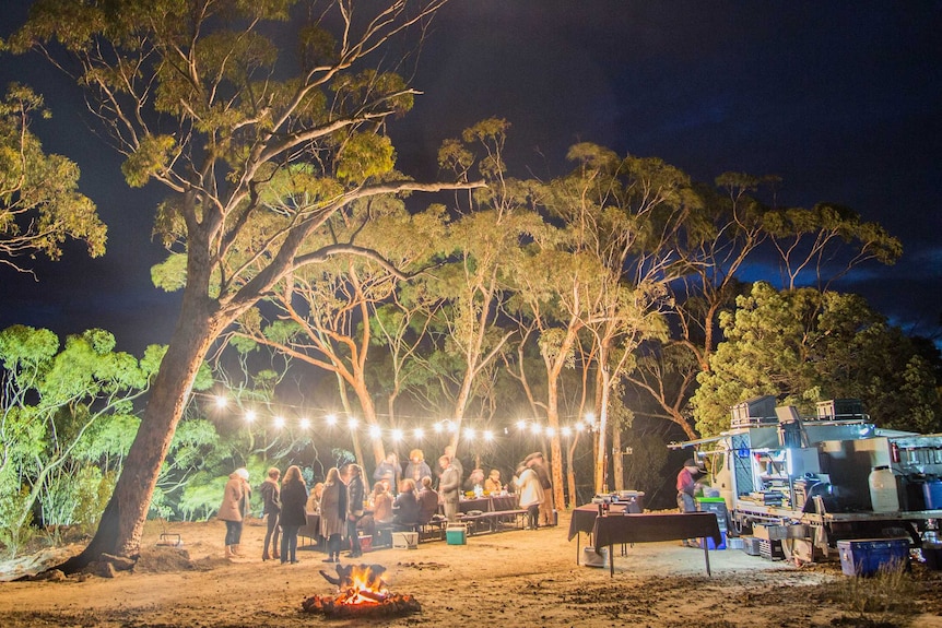 A dinner takes place under the stars.